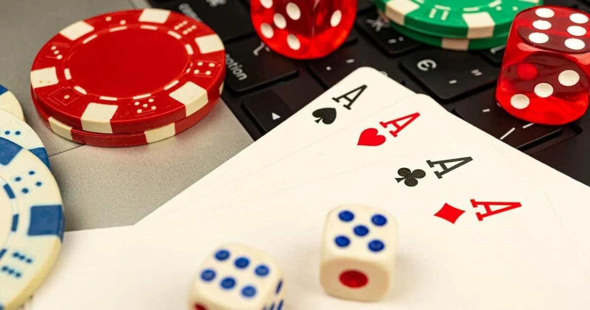 Playing cards, dice and casino chips on a keyboard